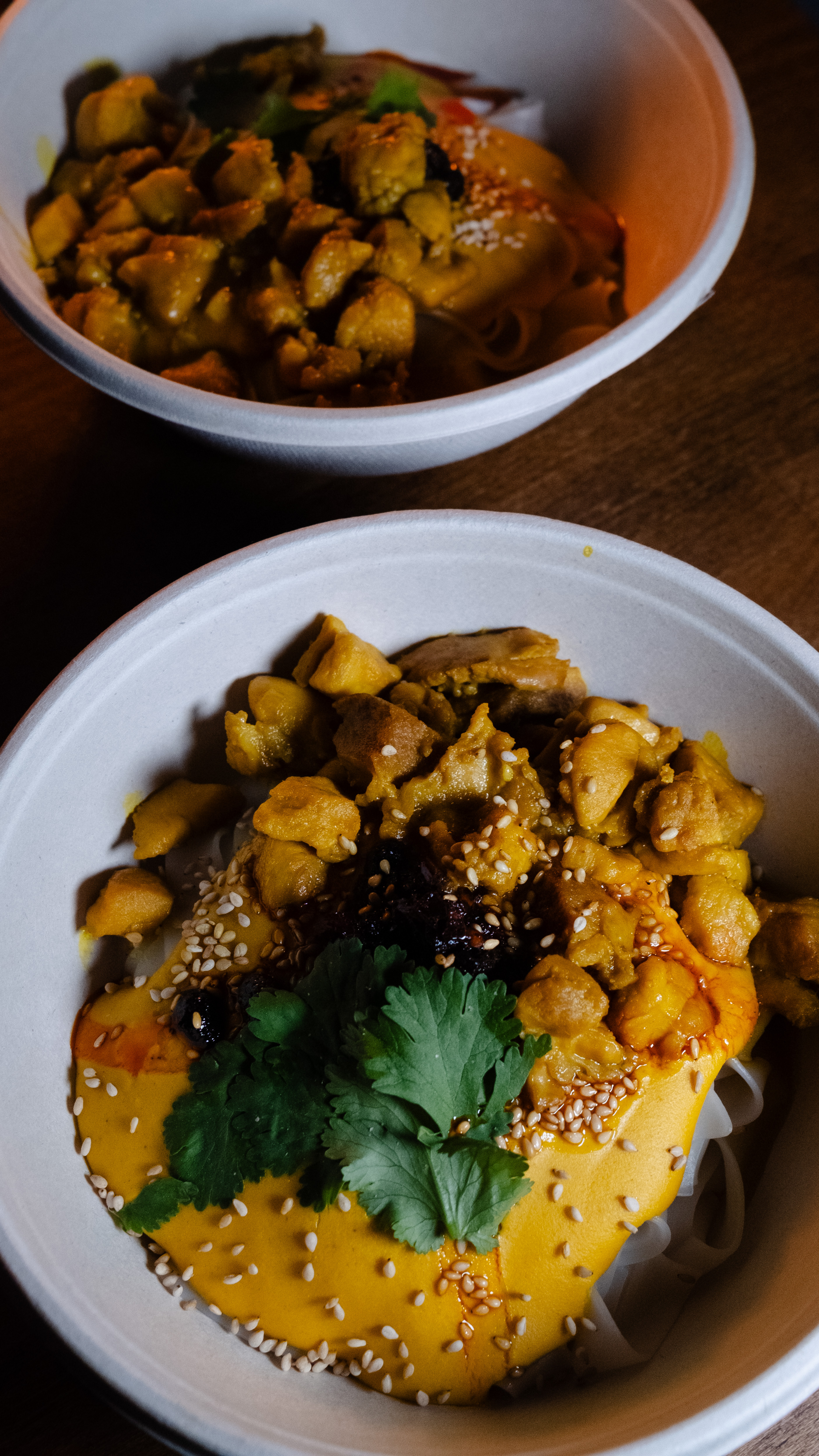 Two okonomiyaki trays served at a market